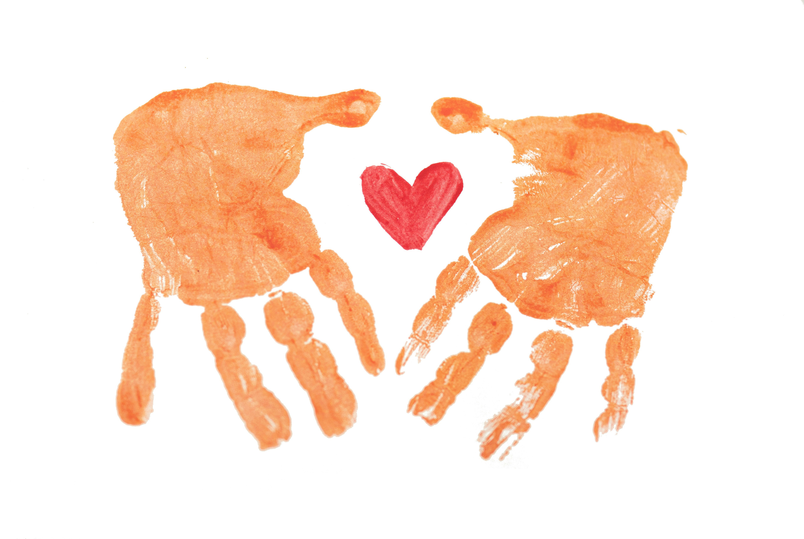 Painted hands surrounding a heart